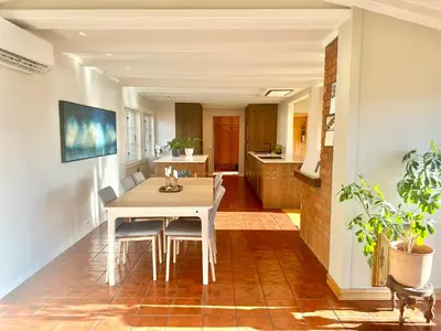 a kitchen and dining room with a table and chairs at Hilltop Panorama view retreat in Ålesund