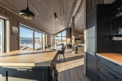 an open kitchen with a view of the mountains at New luxury cabin in Geilo with hot tub, mountain views & ski access in Geilo