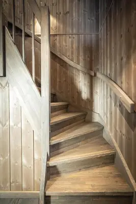 a wooden staircase in a cabin with wood paneling at New luxury cabin in Geilo with hot tub, mountain views & ski access in Geilo