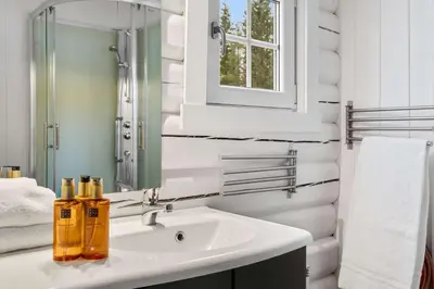 a white bathroom with a sink and a mirror at Vikinggrenda 16A by Vacation Trysil in Trysil