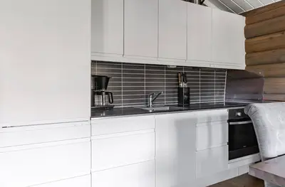 a kitchen with white cabinets and a sink at Vikinggrenda 16A by Vacation Trysil in Trysil