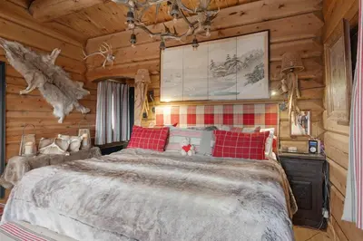 a bedroom with a large bed in a log cabin at Trysilfjell hytteomrade 587 by Vacation Trysil in Hovi