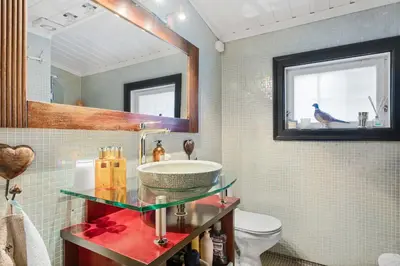 a bathroom with a sink and a mirror and a toilet at Trysilfjell hytteomrade 587 by Vacation Trysil in Hovi