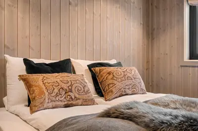 a bed with pillows on it in a room at Trysil hytteomrade 2041 by Vacation Trysil in Hovi