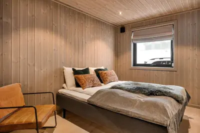 a bedroom with a bed in a room with a window at Trysil hytteomrade 2041 by Vacation Trysil in Hovi