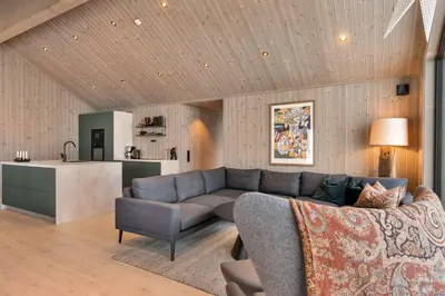 a living room with a couch and a kitchen at Trysil hytteomrade 2041 by Vacation Trysil in Hovi