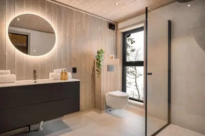 a bathroom with a sink and a toilet and a mirror at Trysil hytteomrade 2041 by Vacation Trysil in Hovi