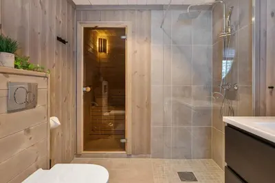 a bathroom with a shower and a toilet and a sink at Trysilfjell hytteomrade 2124 by Vacation Trysil in Hovi