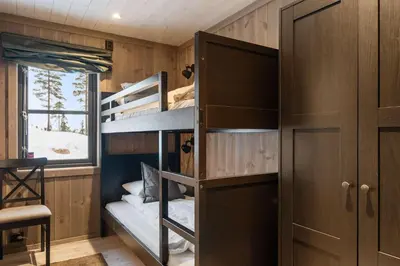 a room with bunk beds and a window at Trysilfjell hytteomrade 2124 by Vacation Trysil in Hovi