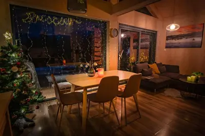 a living room with a table and a christmas tree at Unique Nature Hideaway Close to Norefjell