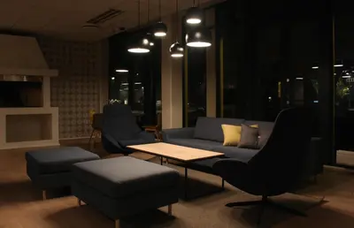 a living room with a couch and a table and chairs at Trudvang Apartment Hotel in Rena