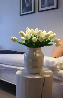 a vase filled with white flowers sitting on a table at Trudvang Apartment Hotel in Rena
