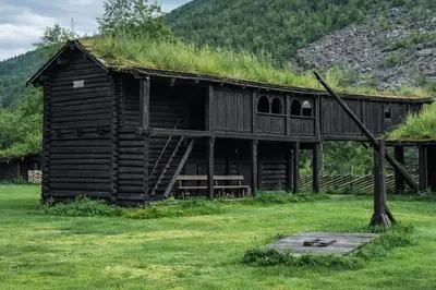 an old log cabin with a grass roof at Jørundgard Vikingcamp in Sel