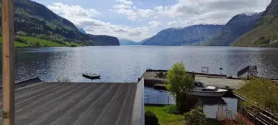 a view of a lake with a boat on a dock at Grodås Lake View Apartment in Hornindal