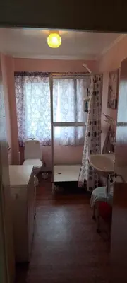 a bathroom with a window and a sink and a toilet at Grodås Lake View Apartment in Hornindal