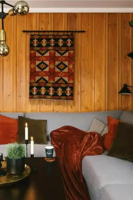 a living room with a couch with a blanket at Modern Cottage With River Frontage Near Opphus in Rena