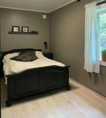 a bedroom with a bed in a room with a window at Modern Cottage With River Frontage Near Opphus in Rena