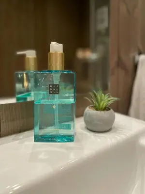 a bottle of soap sitting on top of a bathroom sink at Modern Cottage With River Frontage Near Opphus in Rena