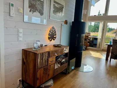 a room with a wooden dresser with a lamp on it at TexasToppen, cabin in Hafjell with sauna in Hafjell