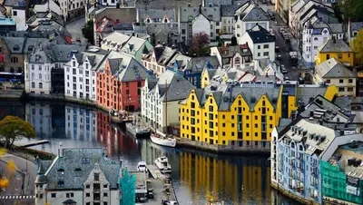 a view of a city with a river and buildings at Nordic Nook - Modern downtown apartment in Ålesund