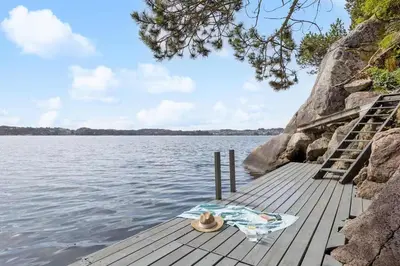 a hat sitting on a dock on a body of water at RVH29 - Fjord Hideaway Villa in Veland