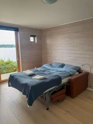a bedroom with a bed in a room with a window at RVH29 - Fjord Hideaway Villa in Veland
