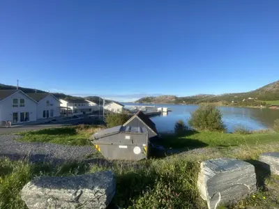 a small boat on the shore of a lake at 5 person holiday home in Flatanger in Vik