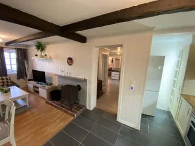 a living room with a fireplace and a table at 5 person holiday home in Flatanger in Vik