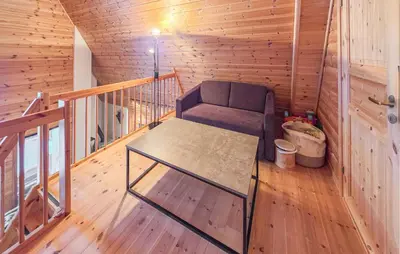 a room with a couch and a table in a cabin at Beautiful Apartment In Bjorli With Sauna in Bjorli