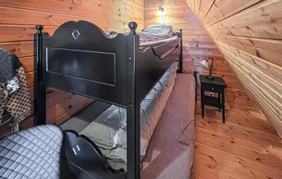 a room with two bunk beds in a cabin at Beautiful Apartment In Bjorli With Sauna in Bjorli