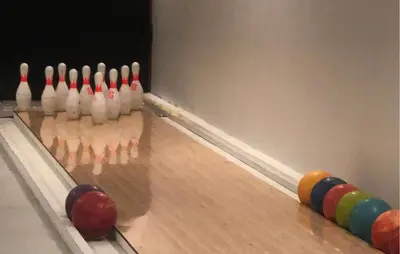 a bowling alley with a ball and pins on the lanes at Beautiful Apartment In Bjorli With Sauna in Bjorli
