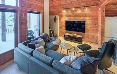 a living room with a blue couch and a television at Beautiful Apartment In Bjorli With Sauna in Bjorli