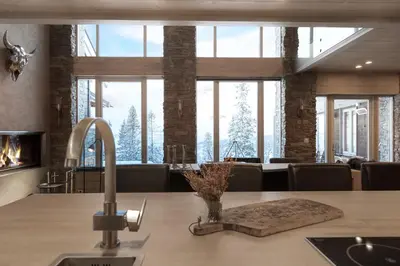 a kitchen with a large window with a fireplace at Fjellspa med Fantastisk utsikt og Høy standard in Aurdal