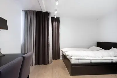 a bedroom with a bed and a window with curtains at Fjellspa med Fantastisk utsikt og Høy standard in Aurdal