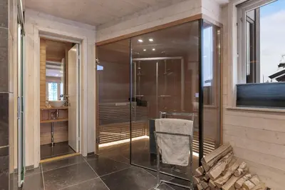 a bathroom with a glass shower with a towel at Fjellspa med Fantastisk utsikt og Høy standard in Aurdal