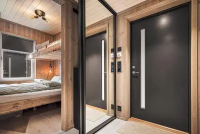 a large door in a room with a bunk bed at Exclusive and Uniqe Apartment - Ski in ski out! in Vossevangen