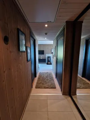 a hallway with wooden walls and a hallway with rugs at Exclusive and Uniqe Apartment - Ski in ski out! in Vossevangen