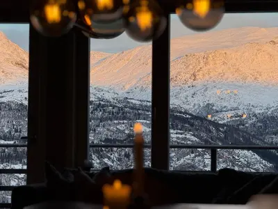 a view of a snowy mountain from a window at Hemsedal, Ski-in ski-out, Skarsnuten Panorama in Hemsedal
