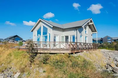 a house on a bluff on a beach at Ocean view and jacuzzi in Forland