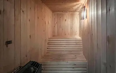 a sauna with wooden walls and stairs in a room at Lovely Home In Sjusjøen With Sauna in Sjusjøen