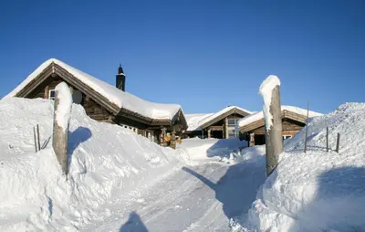 a house covered in snow in front at Lovely Home In Sjusjøen With Sauna in Sjusjøen