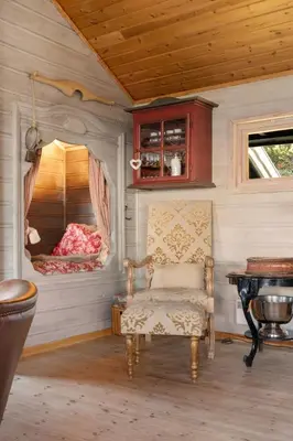 a room with a chair and a table at Bekkeblom, family cabin with extension in Hafjell in Hafjell