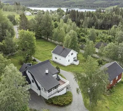 an aerial view of a white house with a garage at A Cozy Nordic Home in Ålset