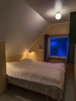 a bedroom with a bed and a window at Charming Norwegian Cottage in Lyngen