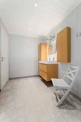 a bathroom with a sink and a chair in a room at Luxury cabin with amazing views in Stryn