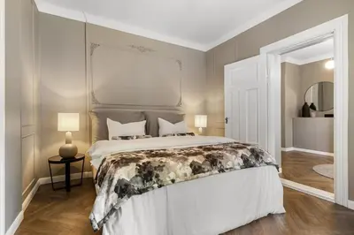 a bedroom with a large white bed in a room at Classic apartment with good standard in the city center in Trondheim