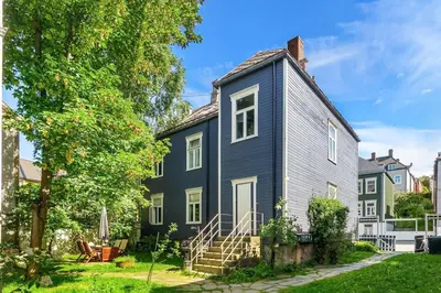 a house with a gray house at Classic apartment with good standard in the city center in Trondheim