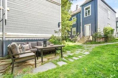 a patio with a couch and a table in a yard at Classic apartment with good standard in the city center in Trondheim