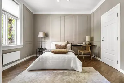a bedroom with a bed and a desk in it at Classic apartment with good standard in the city center in Trondheim