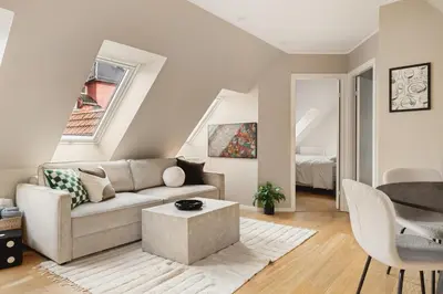 a living room with a couch and a table at Modern apartment on Bryggen Walking distance to everything! in Bergen